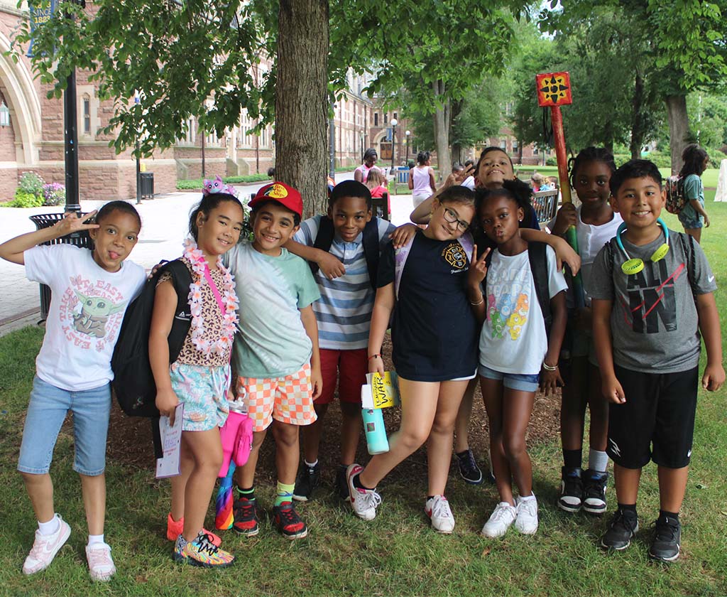 Group of campers posing under a tree